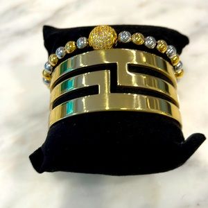 Two bracelets gold with silver beads & large one gold